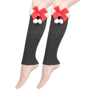 Detailed view of grey ribbed knit leg warmers featuring red bows and white faux fur trim