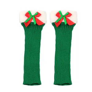 Cozy green Christmas knitted leg warmers featuring white plush trim and festive red bows