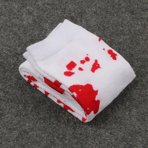 Close-up of white socks with red blood splatter pattern for Halloween cosplay.