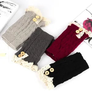 Detailed view of four colorful knitted boot cuffs with lace trim and wooden buttons.