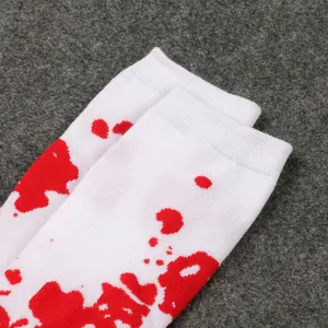 White Halloween socks with realistic red blood splatter pattern for kids' costume