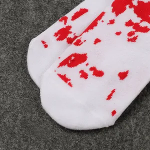Close-up of Halloween children's long socks with red blood splatter patterns