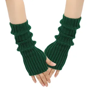 Detailed texture view of dark green knitted fingerless gloves and stylish arm warmers