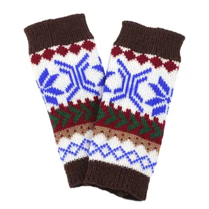 Close-up detail of knitted fingerless arm warmers with festive Christmas snowflake pattern