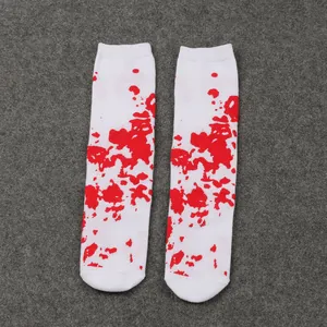Close-up of white Halloween stockings for children featuring a realistic red blood splatter pattern.