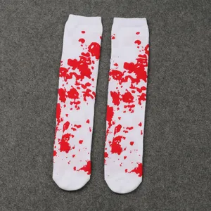 Close-up detail of white Halloween knee-high socks featuring realistic red blood splatter pattern.