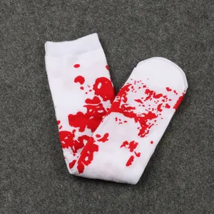 Detailed close-up of white Halloween socks featuring a realistic red blood splatter pattern