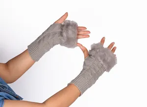 Close-up detail of grey knitted fingerless gloves featuring soft faux fur trim for winter warmth