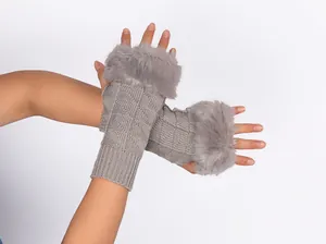 Detailed macro view of gray knitted fingerless gloves with soft faux fur trim for winter