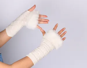 Close-up of white knitted fingerless gloves with faux fur trim for winter
