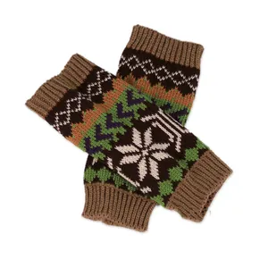 Detailed view of knit fingerless arm warmers with white snowflake and wave pattern