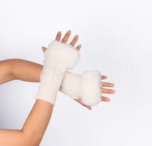 Detail view of off-white knit fingerless gloves with soft fluffy faux fur trim for winter