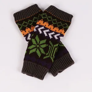 Detailed view of colorful knitted fingerless gloves with a festive snowflake pattern.