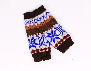 Close-up of colorful knit fingerless arm warmers with blue snowflake patterns.