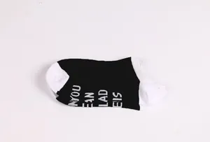 Detail of black and white cotton ankle socks featuring printed 'If You Can Read This' text.