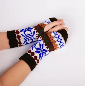 Detail view showing the colorful snowflake pattern on warm winter knitted fingerless gloves