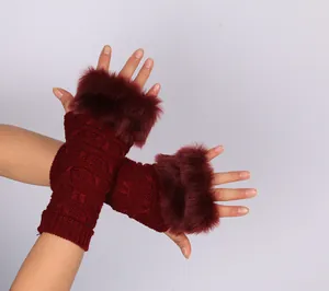 Detailed view of burgundy fingerless knit gloves featuring plush faux fur trim for winter warmth