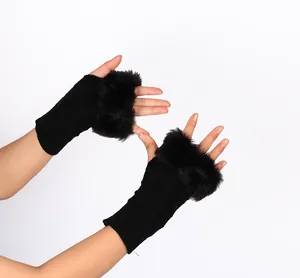 Detailed macro view of black knitted fingerless gloves featuring soft faux rabbit fur trim