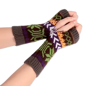 Close-up detail of knitted fingerless gloves with colorful snowflake and geometric patterns