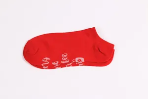 Macro view of red leisure ankle socks with white letters printed on the sole