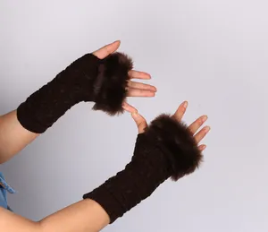 Close-up detail of dark brown knit fingerless gloves featuring thick faux fur trim for winter