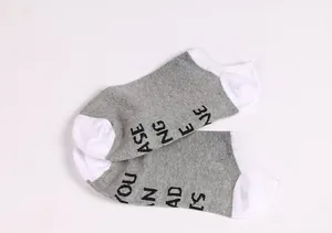 Grey and white ankle socks featuring witty black letter printing on soles
