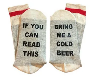 Detail view of cotton socks with 'BRING ME A COLD BEER' text on soles