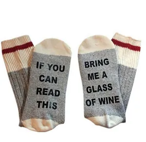 Detail showing humorous 'Bring me wine' text printed on cotton crew socks soles