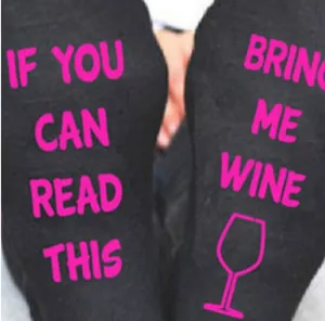 Close-up detail of 'If You Can Read This Bring Me Wine' text on novelty socks
