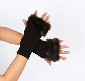 Close-up of brown knitted fingerless gloves with soft faux fur trim for winter warmth.