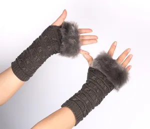 Detailed view of dark grey knitted fingerless gloves with soft faux fur trim.