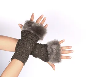 Detail of brown knitted fingerless gloves with elegant grey faux fur trim for winter