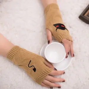 Detailed view of Halloween devil embroidered camel knitted fingerless arm warmers