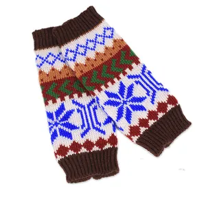 Winter knitted fingerless arm warmers with blue snowflake patterns on a clean white background
