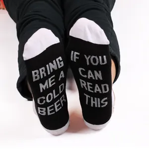 Novelty cotton socks with humorous 'Bring Me a Cold Beer' text on soles
