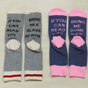 Detail showing knitted funny wine quote on bottom of unisex crew socks