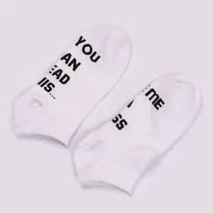 Pair of white cotton ankle socks with novelty black text printed on the soles