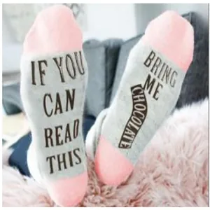 Detailed macro view of funny cotton socks featuring Bring Me Chocolate text design on soles