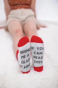 Close-up detail of funny novelty socks featuring 'If you can read this' wine text print