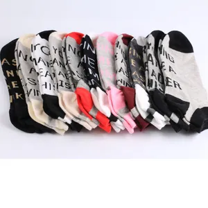 Row of colorful ankle socks with various letter prints like 'LEADER' and 'FINDING'.