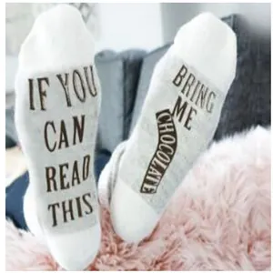 Close-up of funny 'Bring Me Chocolate' text design on white cotton socks