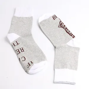 Detailed view of novelty cotton socks featuring funny chocolate quote in grey and white
