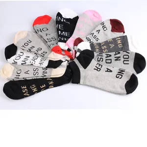 Detailed view of colorful ankle socks with fun letter patterns for men and women