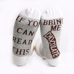 Detail view of cotton socks with funny message If You Can Read This Bring Me Chocolate