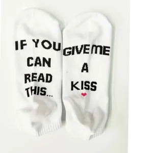 Close-up view of white socks with funny English text If you can read this give me a kiss