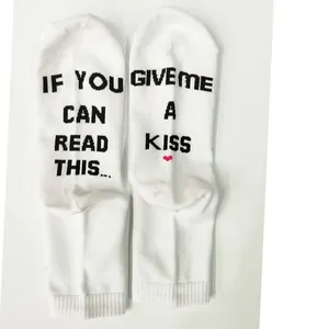 Detail view of white cotton socks with funny 'IF YOU CAN READ THIS' sole print