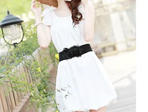 Macro view of elegant black elastic floral waist belt styled on a white summer dress