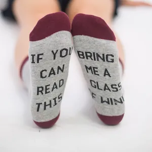 Detailed macro close-up showing creative lettered soles on gray and red cotton crew socks