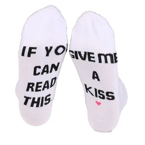 Novelty white ankle socks featuring 'If you can read this give me a kiss' text on the soles