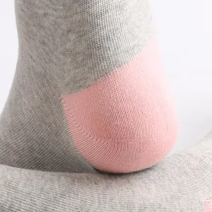 Detailed macro view of a grey and pink cotton sock heel highlighting the fine knit texture